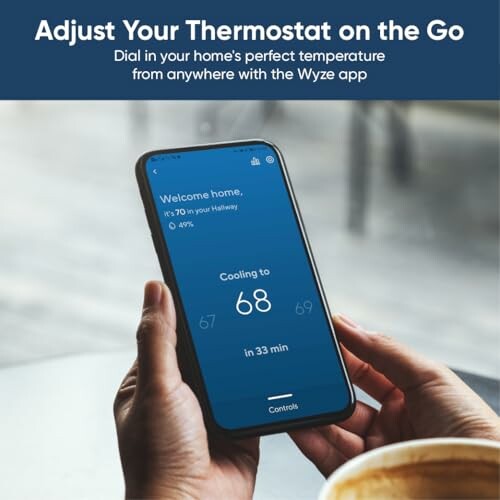 Person using a smartphone to adjust home thermostat temperature with Wyze app.