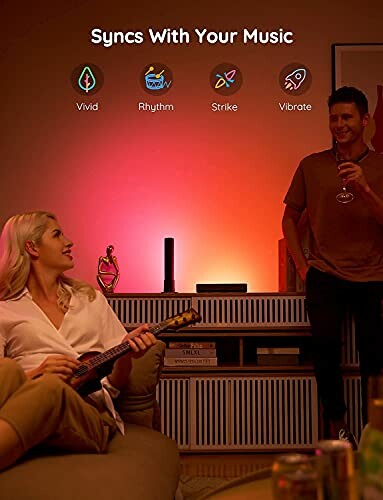 Two people enjoying smart lighting synced with music in a cozy room.