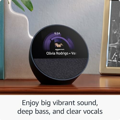 Smart speaker displaying music by Olivia Rodrigo on a table