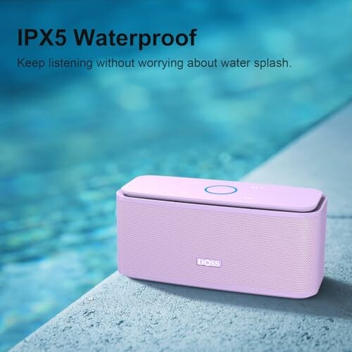 Pink waterproof speaker by a poolside.