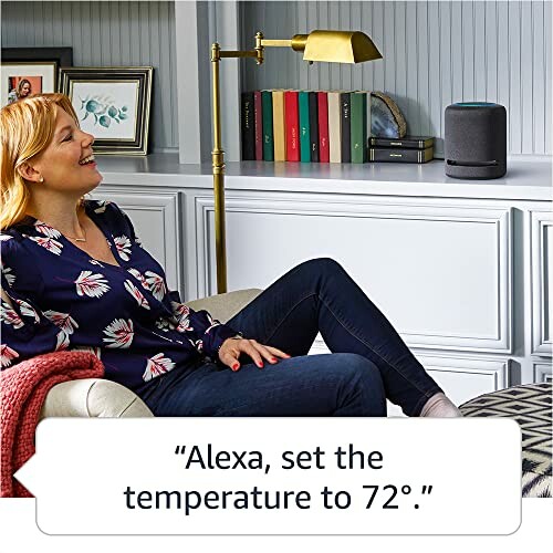 Woman relaxing on a couch using a smart speaker to set the temperature.